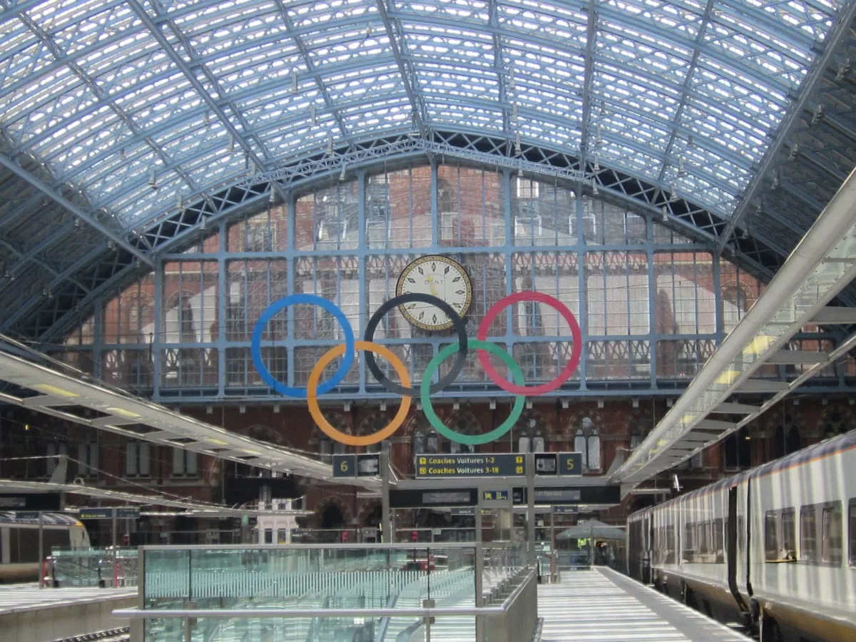 Clock and Olympic rings beneath the glass roof at St Pancras station, London